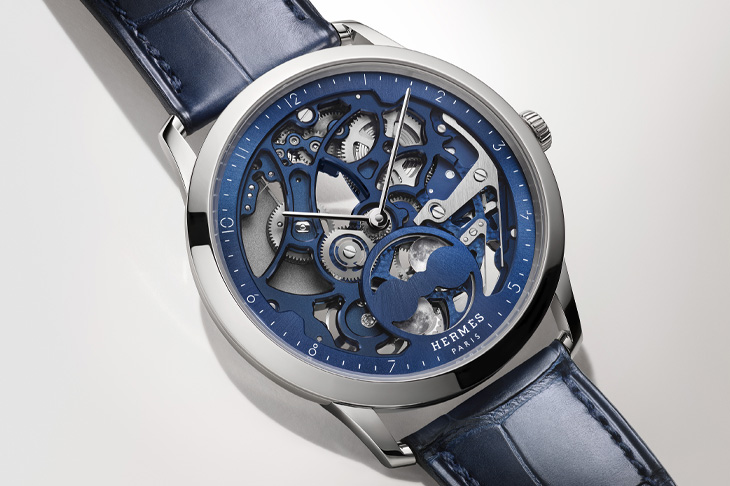 鉑金藍面、鈦金屬灰面雙版本／愛馬仕Slim d’Hermès Squelette Lune鏤空月相腕錶